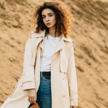 A Girl with jacket standing in from of mountain